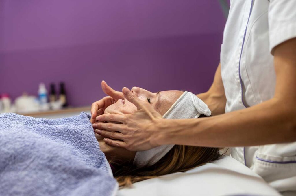 young-woman-being-pampered-with-facial-massage