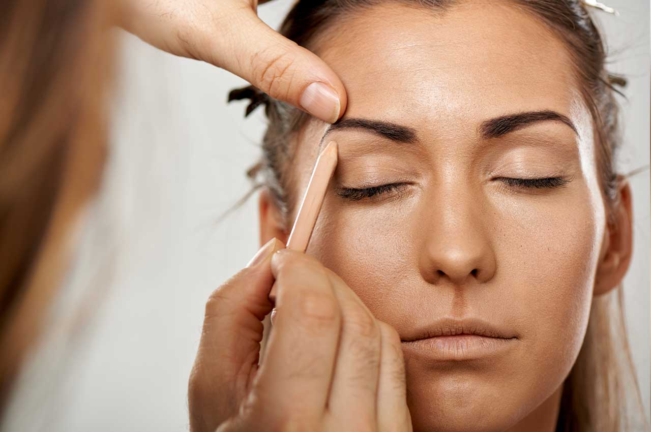 close-up-of-makeup-artist-applying-eyebrow-pencil